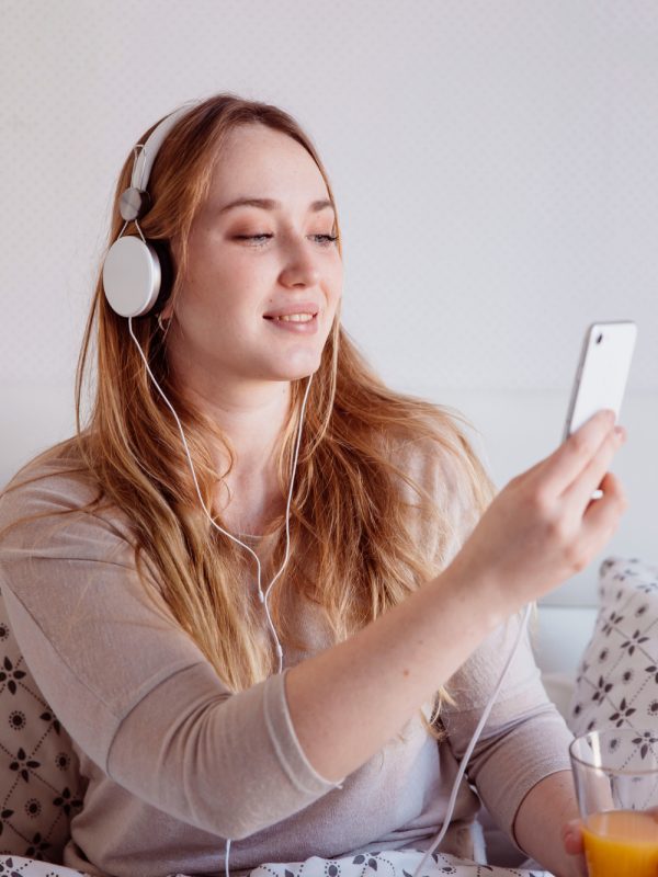 woman-with-juice-listening-music