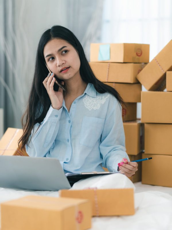 Young woman entrepreneur selling online product and use laptop in her workplace.